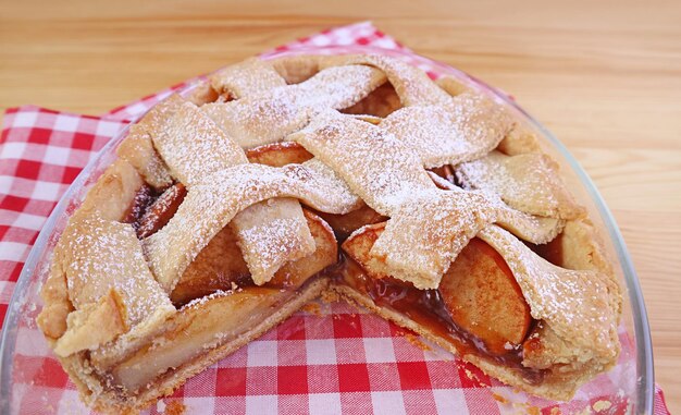 Close up of delectable homemade apple pie fillings texture in the glass baking bowl