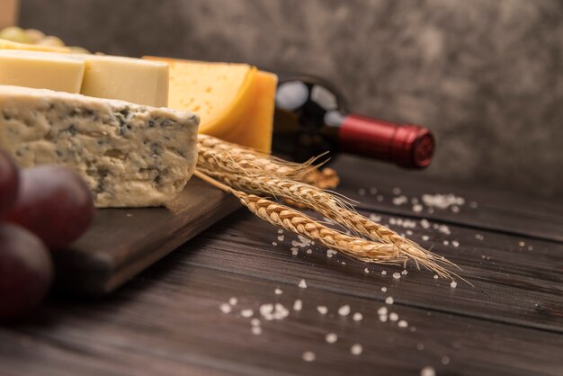 Close-up delicious cheese with bottle of wine