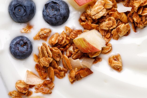 Close up Delicious healthy breakfast bowl with white yogurt fresh blueberries with granola or muesli