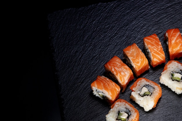 Close up delicious Japanese food sushi over dark background with copy space