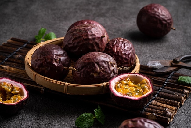 Close up of delicious juicy fresh passion fruit on gray table background.