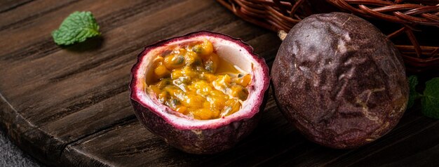 Close up of delicious juicy fresh passion fruit on gray table background.