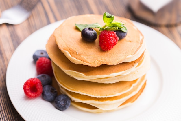 close-up delicious pancakes with fresh blueberries and raspberries.