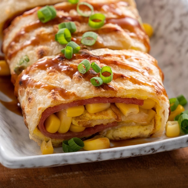 Close up of delicious Taiwanese omelette egg pancake roll with ham and corn kernels famous breakfast in Taiwan