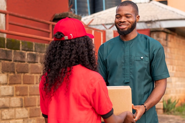 Photo close up on delivery person giving parcel to client