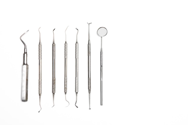 Photo close-up of dental instruments over white background