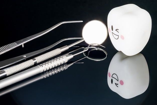 Close up; Dental tools and smile teeth model