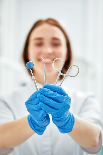 Close-up of dentist's hands and dental equipment.