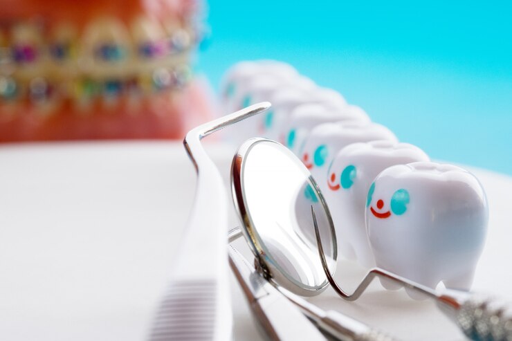Close up.Dentist tools and smile teeth model