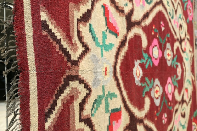 Close-up of designed carpet hanging outdoors