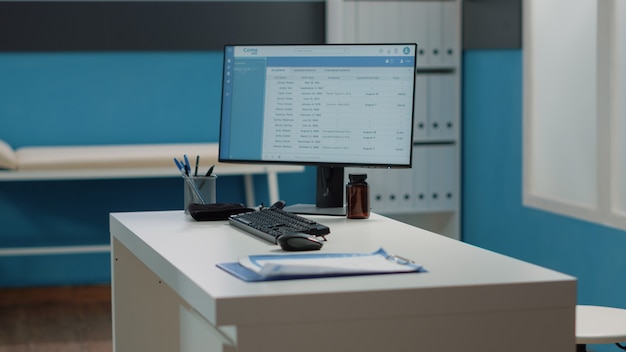 Close up of desk with computer and medical instruments