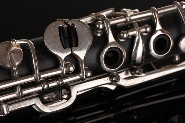 Close up detail of clarinet on black background