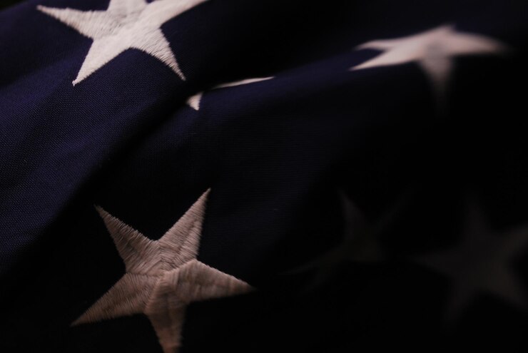 Photo close up detail of a few white stars on blue field american flag