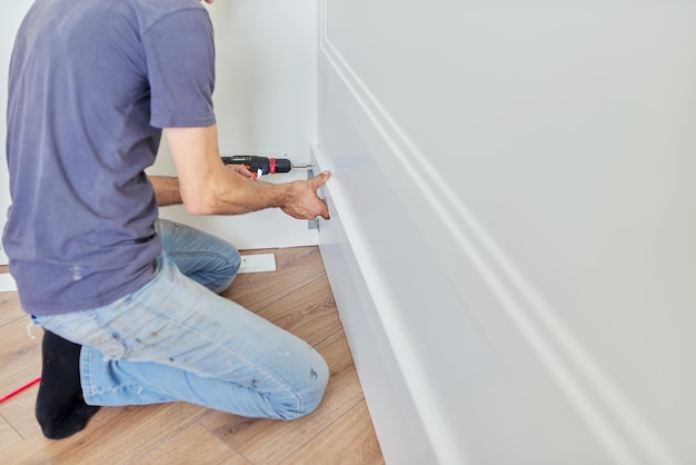 Close up detail of furniture and hands of carpenter worker with professional tool