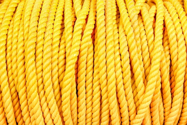 Close up detail of nautical industrial marine yellow coil rope background