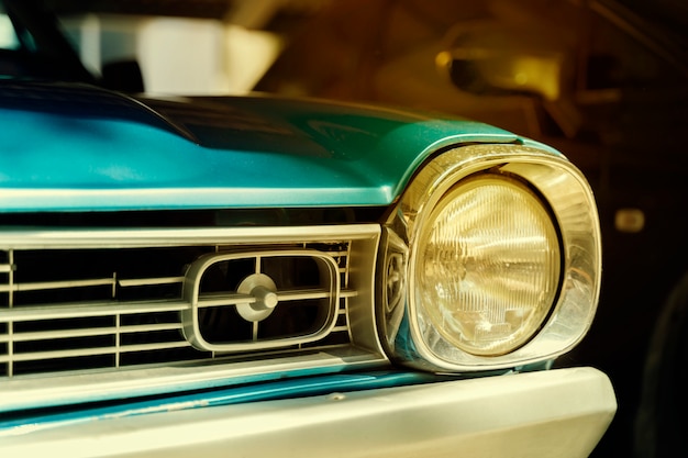 Close-up detail of retro car. Selective focus on the car's headlight.