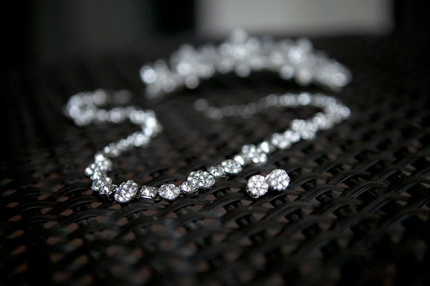 close-up of diamond necklace and earring on table