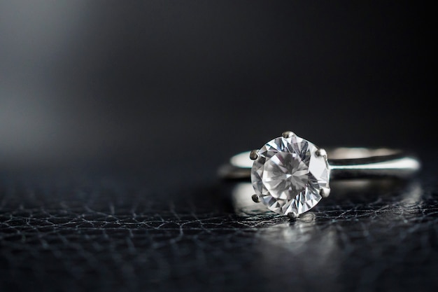 Close up diamond ring jewelry on black leather