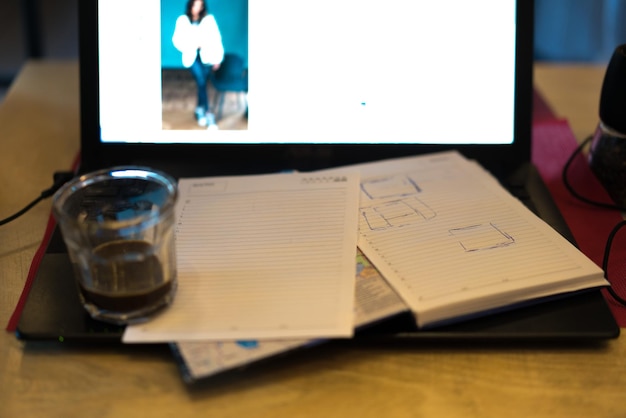 Photo close-up of diary and drink on laptop