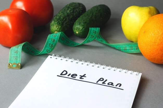 Close up of diet plan and food on table