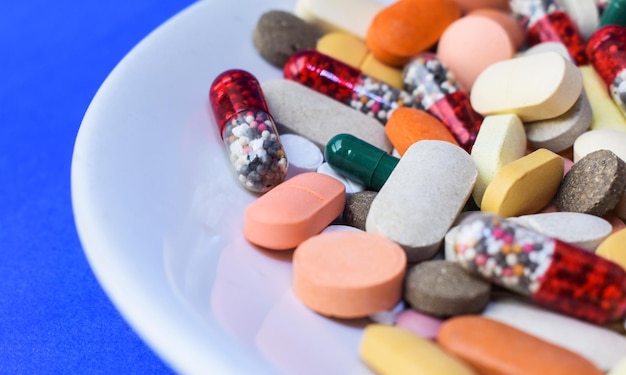 Close up of different medicines on plate groups of capsule