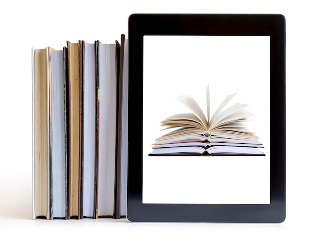 Photo close-up of digital tablet and books against white background