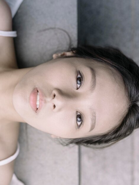 close-up directly above portrait of young woman lying at home