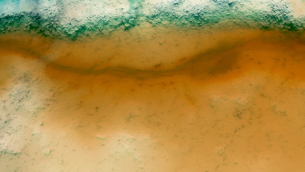 Close-up of dirty orange water seen from above