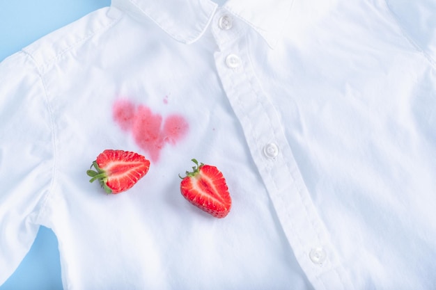 close up dirty stain of strawberry on a white shirt