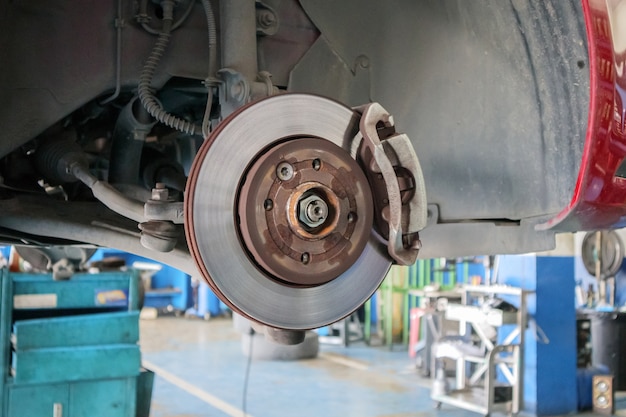 Close up disc brake at car service workshop