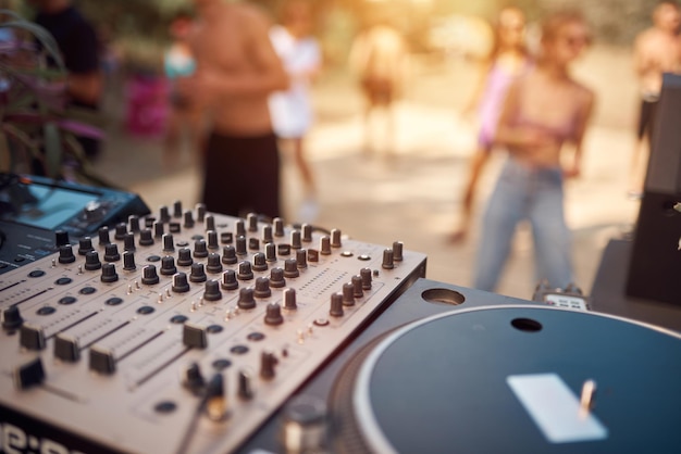 Close up of a DJ playing music on the outdoor party.