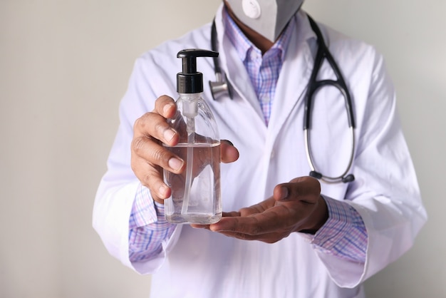 close up of doctor hand using sanitizer gel