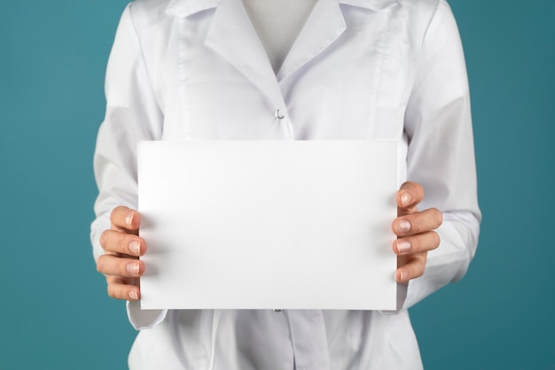 Close up doctor holding blank paper