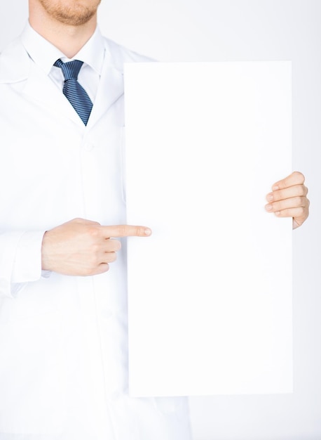 close up of doctor holding blank white banner