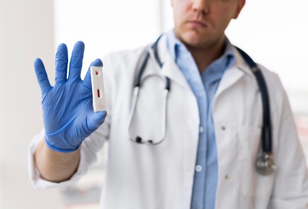 Close-up of a doctor holding a covid sample