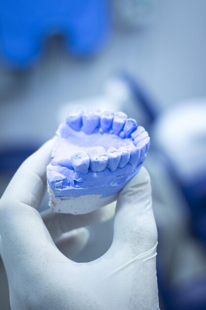 Close-up of doctor holding dentures