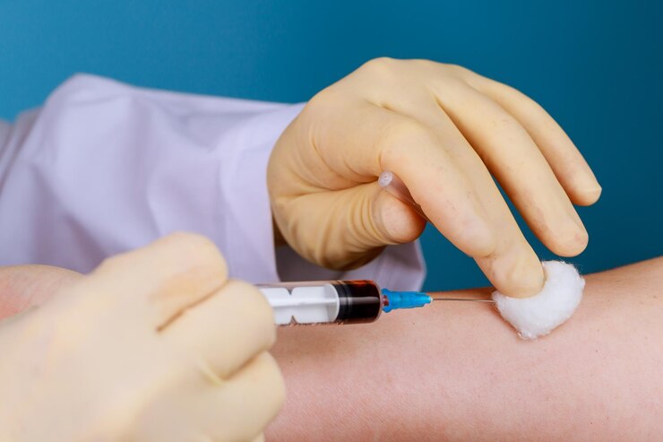 Photo close-up of doctor holding syringe on patient