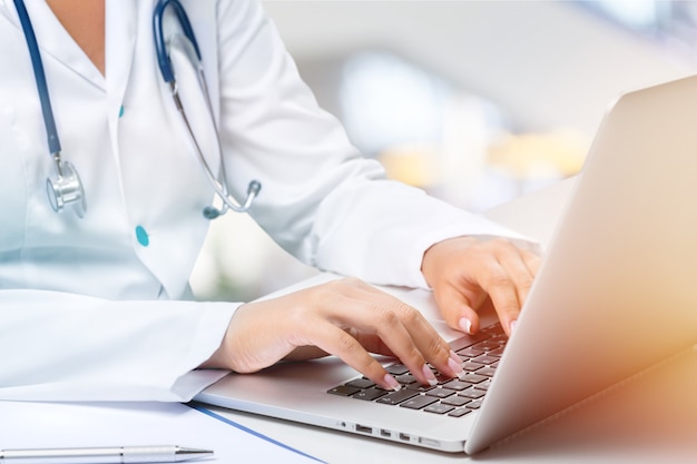 Close-up Doctor at hospital working with laptop