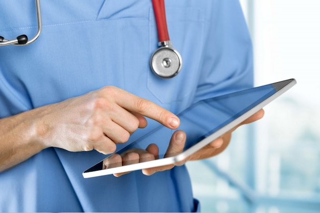 close-up doctor at hospital working with tablet pc