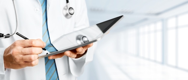 Close-up Doctor at hospital working with tablet pc