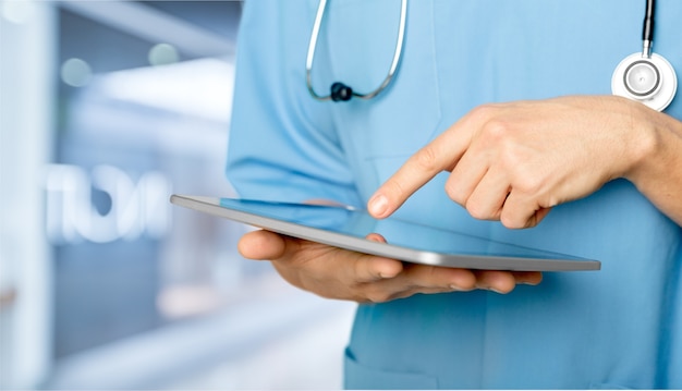 close-up doctor at hospital working with tablet pc