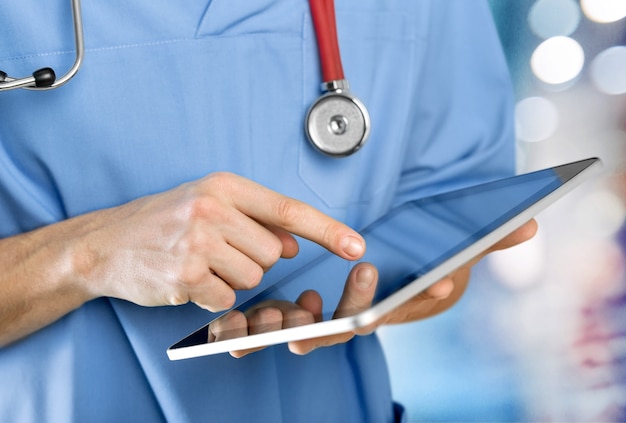 close-up doctor at hospital working with tablet pc