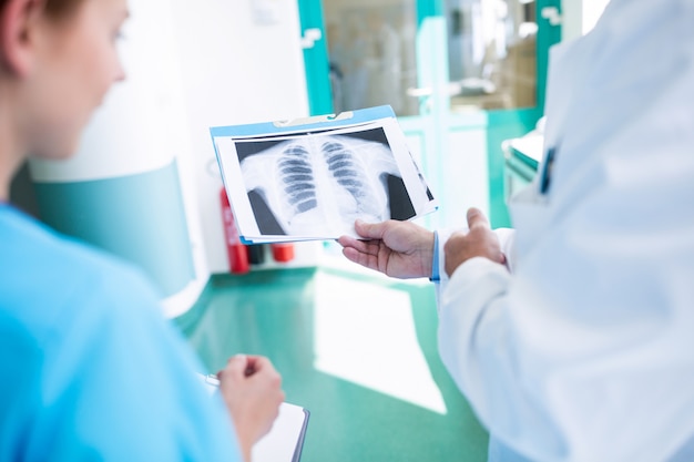 Close-up of doctor and nurses examining an x-ray