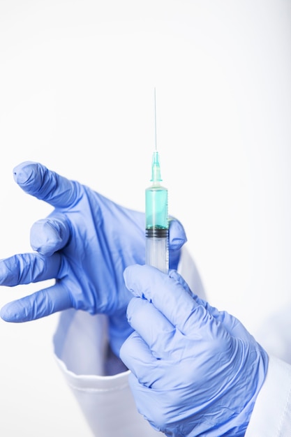 Close up of doctor's hands preparing syringe with new vaccine