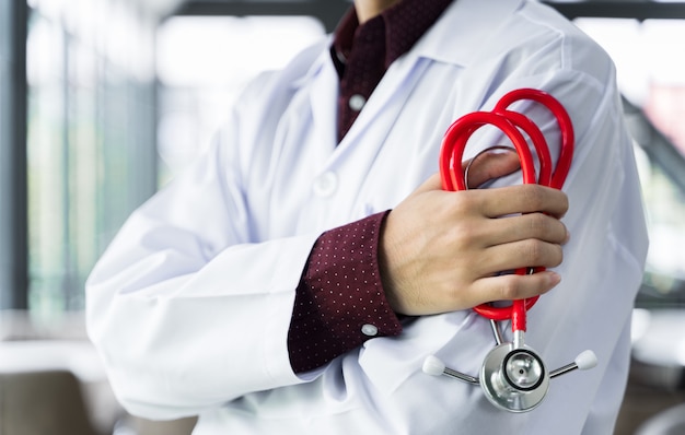 Close up doctor stood and Crossed Arms with a stethoscope at the hospital.