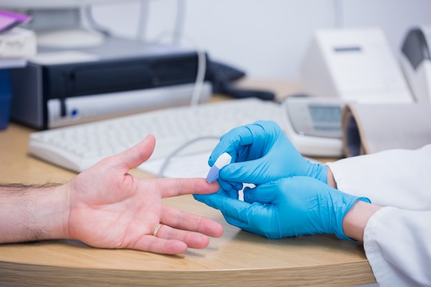 Close up of a doctor testing his patients blood