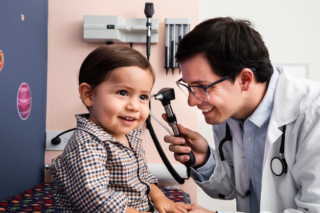 Close-up doctor with otoscope