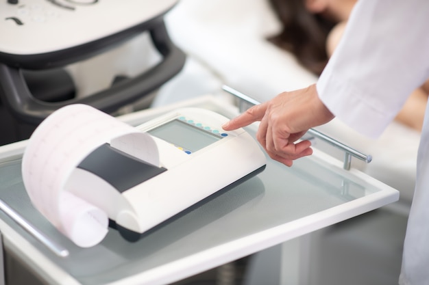 Close up of doctors hand pressing the button