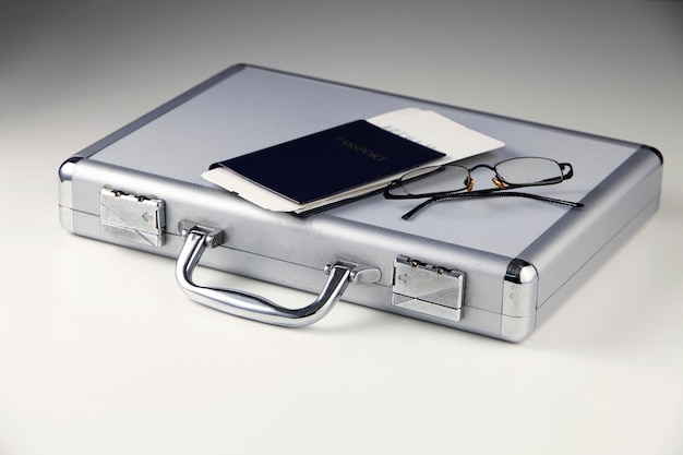 Photo close-up of documents and eyeglasses with briefcase on white background