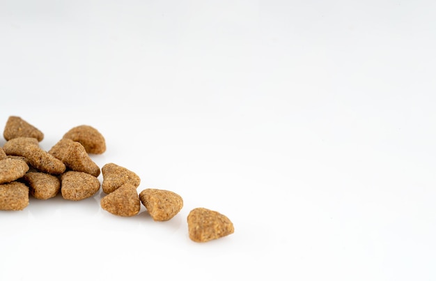 Close up of dog food pellets on white background